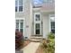 Inviting home entrance with stone steps, decorative planters, and modern lighting at 110 Cadmium Ct, Peachtree City, GA 30269