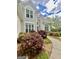 Beautiful home exterior with a curved sidewalk and lush, colorful landscaping at 110 Cadmium Ct, Peachtree City, GA 30269