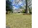 Beautiful two-story home with lush green lawn, mature landscaping, and classic architectural details at 110 Cadmium Ct, Peachtree City, GA 30269