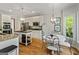 Spacious kitchen with stainless steel appliances, white cabinets, and a breakfast nook overlooking the yard at 110 Cadmium Ct, Peachtree City, GA 30269