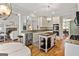 Well-lit kitchen featuring granite countertops, white cabinets, and a rustic center island at 110 Cadmium Ct, Peachtree City, GA 30269