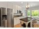 Bright kitchen with stainless steel appliances, white cabinetry, and an island with seating at 110 Cadmium Ct, Peachtree City, GA 30269