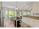 Open kitchen and breakfast area with hardwood floors, granite countertops, and stainless steel appliances at 110 Cadmium Ct, Peachtree City, GA 30269
