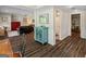 Open living area with hardwood floors, a blue cabinet, and access to a bathroom and gym at 110 Cadmium Ct, Peachtree City, GA 30269