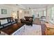 Living room featuring dual couches, accent pillows, area rug, and hardwood flooring at 110 Cadmium Ct, Peachtree City, GA 30269