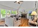 Spacious living room with vaulted ceiling, stone fireplace, hardwood floors, and ample natural light from large windows at 110 Cadmium Ct, Peachtree City, GA 30269