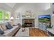 Cozy living room features a stone fireplace, hardwood floors, and neutral decor at 110 Cadmium Ct, Peachtree City, GA 30269