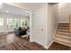 Bright and inviting living room with wood floors, a cozy sofa, and a staircase at 110 Cadmium Ct, Peachtree City, GA 30269