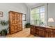 Cozy office space featuring hardwood floors, natural light, and a rustic armoire at 110 Cadmium Ct, Peachtree City, GA 30269
