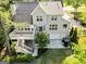 Aerial view of a home showcasing its deck, two-car garage, and lush surroundings at 110 Cadmium Ct, Peachtree City, GA 30269