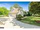 Charming home featuring a side entry garage, well-kept lawn, and mature landscaping at 110 Cadmium Ct, Peachtree City, GA 30269