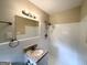 Bathroom featuring a granite countertop vanity, shower, and white tiling at 668 Fielding Sw Ln, Atlanta, GA 30311
