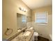 Cozy bathroom featuring updated vanity, granite counters, modern fixtures, tiled walls, and natural light at 668 Fielding Sw Ln, Atlanta, GA 30311