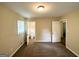 Bedroom features neutral walls, carpet, and a door to a bathroom at 668 Fielding Sw Ln, Atlanta, GA 30311