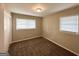 Bedroom featuring neutral walls, plush carpet, and two windows that bring in natural light at 668 Fielding Sw Ln, Atlanta, GA 30311