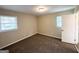 Bedroom with neutral walls, carpet, and two windows that bring in natural light at 668 Fielding Sw Ln, Atlanta, GA 30311