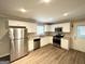 Well-lit kitchen featuring granite counters, stainless steel appliances, updated cabinets, and hardwood floors at 668 Fielding Sw Ln, Atlanta, GA 30311