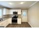 Updated kitchen features granite counters, stainless steel appliances, hardwood floors, and lots of natural light at 668 Fielding Sw Ln, Atlanta, GA 30311