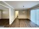 Large living room with hardwood floors, neutral paint, lots of natural light, and an open layout into other living spaces at 668 Fielding Sw Ln, Atlanta, GA 30311