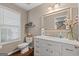 Elegant powder room features a marble countertop, a white vanity and stylish fixtures at 220 Calli Ct, Mcdonough, GA 30252