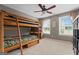 Bedroom with wooden bunkbeds, ceiling fan, and two bright windows at 220 Calli Ct, Mcdonough, GA 30252