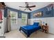 Bedroom with blue walls, white wainscoting, a ceiling fan and two windows at 220 Calli Ct, Mcdonough, GA 30252
