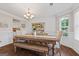 Formal dining room with hardwood floors and a wooden table with a bench and chairs at 220 Calli Ct, Mcdonough, GA 30252