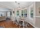 Sunlit dining area showcasing a farmhouse-style table and views of the backyard at 220 Calli Ct, Mcdonough, GA 30252