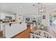Open kitchen and dining area with wooden table and white chairs at 220 Calli Ct, Mcdonough, GA 30252