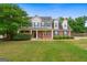 Charming two-story home featuring a welcoming front porch, brick accents, and a well-manicured lawn at 220 Calli Ct, Mcdonough, GA 30252