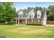 Charming two-story home featuring a welcoming front porch, brick accents, and a well-manicured lawn at 220 Calli Ct, Mcdonough, GA 30252