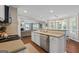 Open-concept kitchen with views to the living room, featuring an island and modern finishes at 220 Calli Ct, Mcdonough, GA 30252