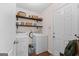 Practical laundry room with washer, dryer, shelving and access to an exterior door at 220 Calli Ct, Mcdonough, GA 30252