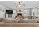 Inviting living room features a brick fireplace, a large television, and a comfortable beige sectional sofa at 220 Calli Ct, Mcdonough, GA 30252