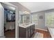 Spacious main bathroom features double sinks, a large mirror, and a walk-in closet at 220 Calli Ct, Mcdonough, GA 30252