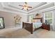 Spacious main bedroom features a tray ceiling, neutral colors and comfortable furnishings at 220 Calli Ct, Mcdonough, GA 30252
