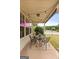 Cozy covered patio featuring a wrought iron table set and charming string lights at 220 Calli Ct, Mcdonough, GA 30252