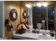 A bathroom featuring a white vanity countertop with decorative objects and ornate wall decor at 472 Harvick Cir, Stockbridge, GA 30281
