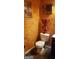 This bathroom features a toilet, framed prints, dark vanity and colorful textured walls at 472 Harvick Cir, Stockbridge, GA 30281