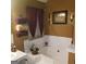 A bathtub with decorative touches including decorative window treatment and ornate wall decor at 472 Harvick Cir, Stockbridge, GA 30281