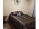 This bedroom features neutral walls, a decorative wall piece and a patterned bedspread at 472 Harvick Cir, Stockbridge, GA 30281