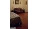 This bedroom features hardwood floors, a leather couch, and lamps on end tables at 472 Harvick Cir, Stockbridge, GA 30281