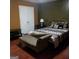 The bedroom is furnished with a bed, chaise lounge and television stand, offering a cozy retreat at 472 Harvick Cir, Stockbridge, GA 30281