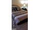 Bedroom with a comfortable bed covered with black and white patterned comforter at 472 Harvick Cir, Stockbridge, GA 30281