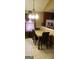 Dining area with a granite-look table, chandelier, and tile floor at 472 Harvick Cir, Stockbridge, GA 30281