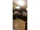This kitchen features dark wood cabinets, stainless steel appliances, and tile flooring at 472 Harvick Cir, Stockbridge, GA 30281