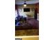This living room features a mounted television, hardwood floors, and comfortable looking seating at 472 Harvick Cir, Stockbridge, GA 30281