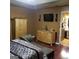 A main bedroom featuring a chaise lounge, wood floors, and natural wood furniture at 472 Harvick Cir, Stockbridge, GA 30281