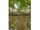 Secluded backyard with black chainlink fence and lush trees providing shade for relaxed outdoor living at 5363 Forest Dr, Loganville, GA 30052