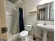 Clean bathroom equipped with standing sink, toilet, and enclosed shower at 5363 Forest Dr, Loganville, GA 30052